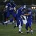 Pioneer senior linebacker Michael Sherman (left) celebrates with his team after recovering a fumble and scoring a touchdown against Skyline on Friday. Pioneer won 50-0. Daniel Brenner I AnnArbor.com